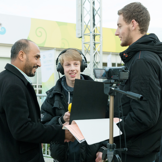 Zwei Jugendliche im Interview mit einem Erwachsenen